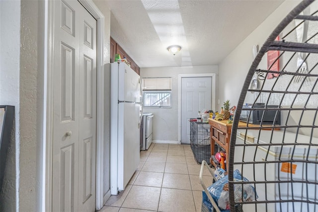 1799 Russell St S, Saint Petersburg, FL 33712 - kitchen featuring freestanding refrigerator, a textured ceiling, light tile patterned flooring, range, and a textured wall