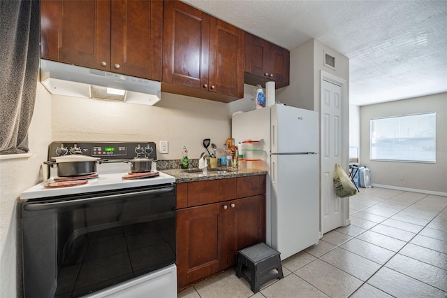 1799 Russell St S, Saint Petersburg, FL 33712 - kitchen with range with electric cooktop, under cabinet range hood, freestanding refrigerator, light tile patterned flooring, and a textured ceiling