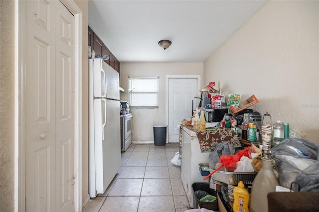 1799 Russell St S, Saint Petersburg, FL 33712 - kitchen with white appliances, dark brown cabinetry, and light tile patterned floors