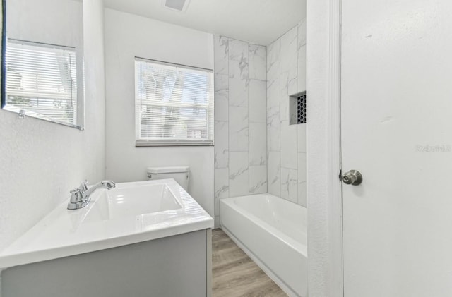 1807 E Bougainvillea Ave, Tampa, FL 33612 - full bathroom featuring vanity, wood finished floors, and tub / shower combination