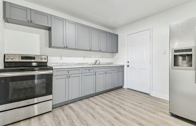 1807 E Bougainvillea Ave, Tampa, FL 33612 - kitchen featuring stainless steel appliances, gray cabinets, light wood finished floors, and light countertops