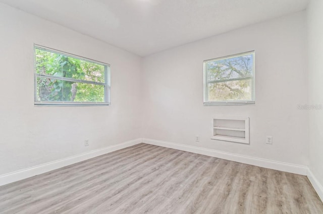 1807 E Bougainvillea Ave, Tampa, FL 33612 - unfurnished room featuring light wood finished floors and baseboards