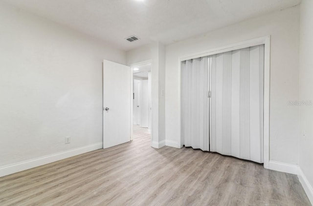 1807 E Bougainvillea Ave, Tampa, FL 33612 - unfurnished bedroom with wood finished floors and a closet
