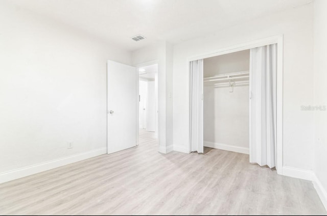 1807 E Bougainvillea Ave, Tampa, FL 33612 - unfurnished bedroom featuring light wood-style floors and a closet