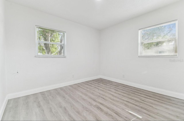1807 E Bougainvillea Ave, Tampa, FL 33612 - spare room featuring wood finished floors