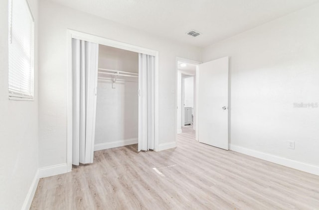 1807 E Bougainvillea Ave, Tampa, FL 33612 - unfurnished bedroom with light wood-type flooring and a closet