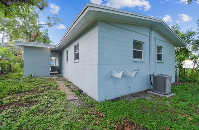 1807 E Bougainvillea Ave, Tampa, FL 33612 - view of side of property featuring a central AC unit