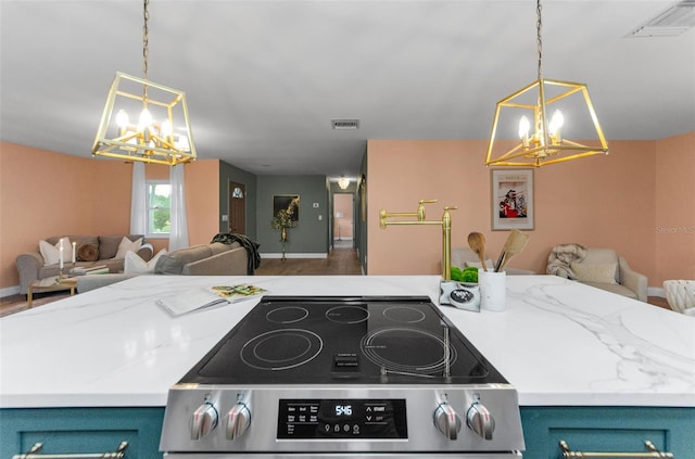 1558 Cottonwood Ter, Dunedin, FL 34698 - kitchen featuring a chandelier, stainless steel stove, open floor plan, and blue cabinets