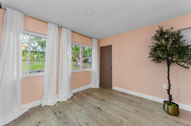 1558 Cottonwood Ter, Dunedin, FL 34698 - empty room featuring baseboards and light wood finished floors