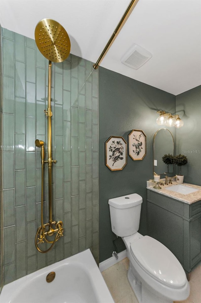 1558 Cottonwood Ter, Dunedin, FL 34698 - bathroom with toilet, vanity, a tile shower, baseboards, and tile patterned flooring