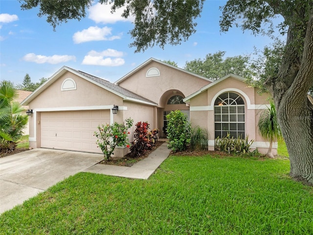 9008 Egret Cove Cir, Riverview, FL 33578 - view of front of home featuring a garage, stucco siding, concrete driveway, and a front yard