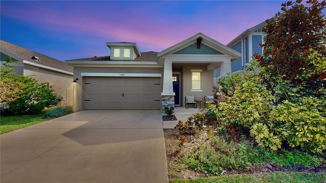 5645 Del Coronado Dr, Apollo Beach, FL 33572 - view of front facade featuring a garage, driveway, and stone siding