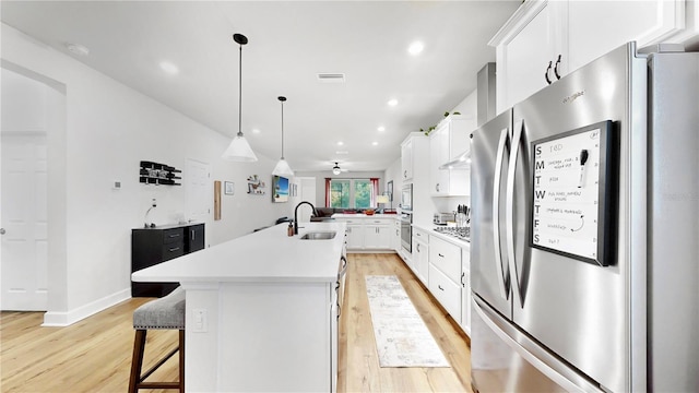 5645 Del Coronado Dr, Apollo Beach, FL 33572 - kitchen featuring appliances with stainless steel finishes, a sink, light wood-style floors, light countertops, and recessed lighting