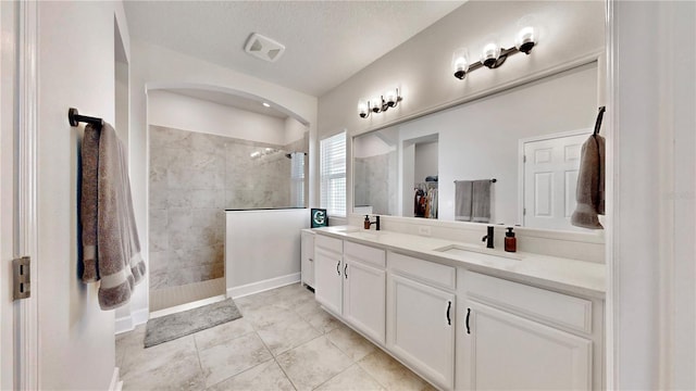 5645 Del Coronado Dr, Apollo Beach, FL 33572 - bathroom with double vanity, walk in shower, a walk in closet, and tile patterned flooring
