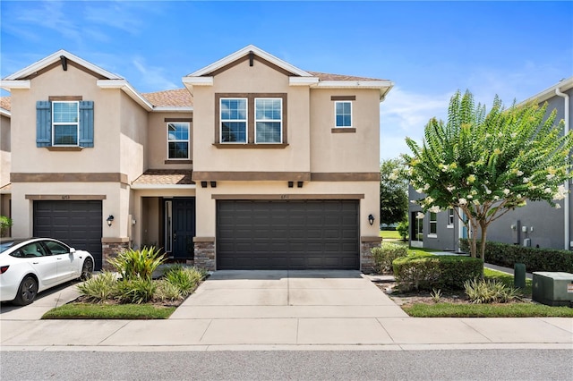 6711 Rocky Park St, Tampa, FL 33625 - view of property featuring stucco siding, a garage, concrete driveway, and stone siding