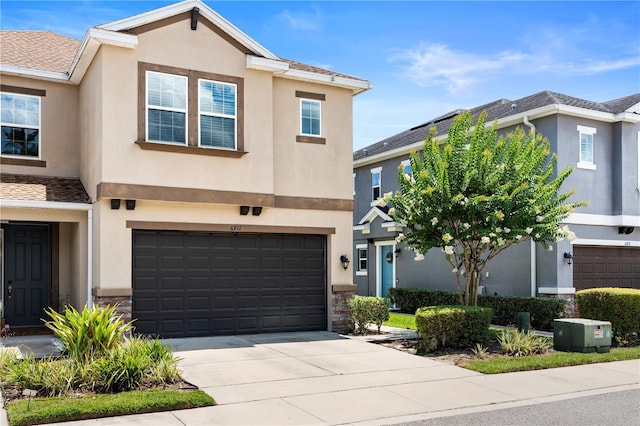 6711 Rocky Park St, Tampa, FL 33625 - townhome / multi-family property with stucco siding, a garage, concrete driveway, and stone siding
