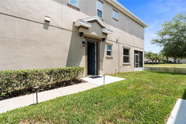 6711 Rocky Park St, Tampa, FL 33625 - entrance to property featuring stucco siding and a yard