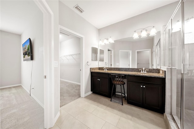 6711 Rocky Park St, Tampa, FL 33625 - bathroom featuring a walk in closet, double vanity, a stall shower, and baseboards