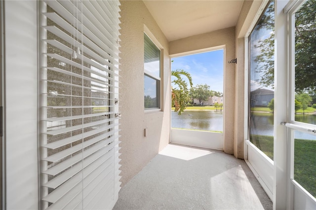6711 Rocky Park St, Tampa, FL 33625 - unfurnished sunroom with a water view, healthy amount of natural light, and a textured wall
