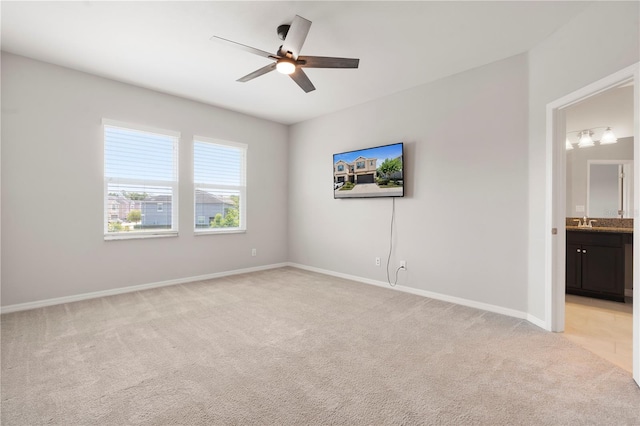 6711 Rocky Park St, Tampa, FL 33625 - unfurnished bedroom with light colored carpet, baseboards, ensuite bathroom, ceiling fan, and a sink