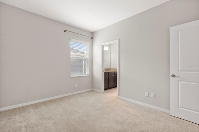 6711 Rocky Park St, Tampa, FL 33625 - unfurnished bedroom with light carpet, baseboards, and connected bathroom