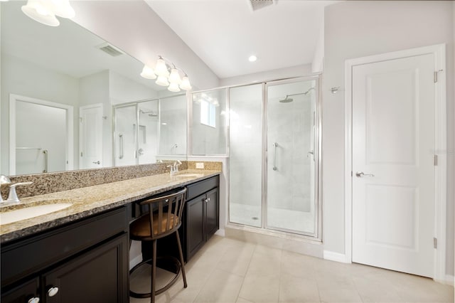 6711 Rocky Park St, Tampa, FL 33625 - bathroom featuring a shower stall, double vanity, tile patterned flooring, and baseboards
