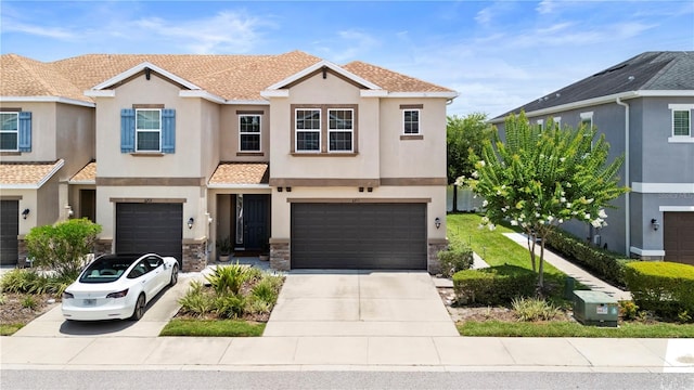 6711 Rocky Park St, Tampa, FL 33625 - view of property with a garage, stucco siding, driveway, and stone siding