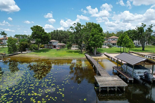 14808 Lake Magdalene Cir, Tampa, FL 33613 - dock with a water view and a lawn
