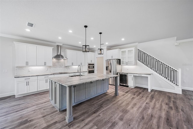14808 Lake Magdalene Cir, Tampa, FL 33613 - kitchen with beverage cooler, wall chimney exhaust hood, appliances with stainless steel finishes, a sink, and crown molding