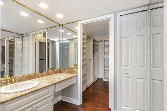 7300 Sun Island Dr S Unit 1505, South Pasadena, FL 33707 - bathroom featuring vanity, wood finished floors, recessed lighting, and a spacious closet