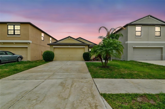 14206 Covert Green Pl, Riverview, FL 33579 - traditional-style home with stucco siding, concrete driveway, a front lawn, and a garage