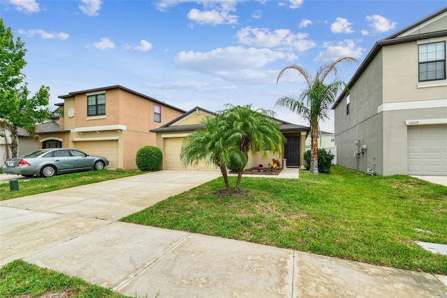 14206 Covert Green Pl, Riverview, FL 33579 - view of front facade with concrete driveway, stucco siding, a front lawn, and an attached garage
