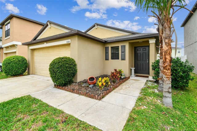 14206 Covert Green Pl, Riverview, FL 33579 - view of front of property featuring stucco siding, an attached garage, and driveway