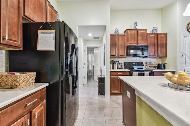14206 Covert Green Pl, Riverview, FL 33579 - kitchen with black appliances, light countertops, light tile patterned floors, and tasteful backsplash