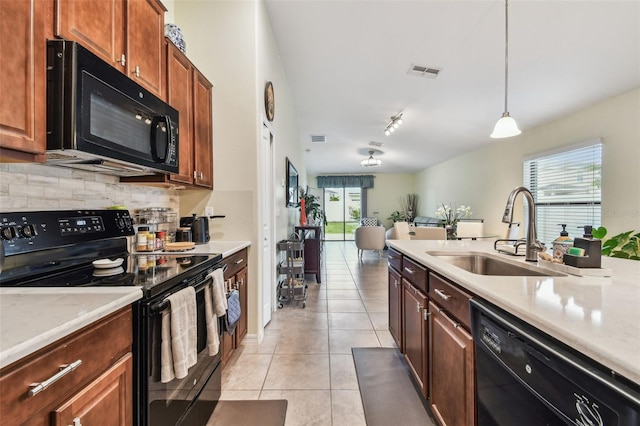 14206 Covert Green Pl, Riverview, FL 33579 - kitchen featuring black appliances, a sink, backsplash, light countertops, and light tile patterned floors