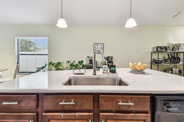 14206 Covert Green Pl, Riverview, FL 33579 - kitchen with a sink, beverage cooler, decorative light fixtures, and light stone countertops