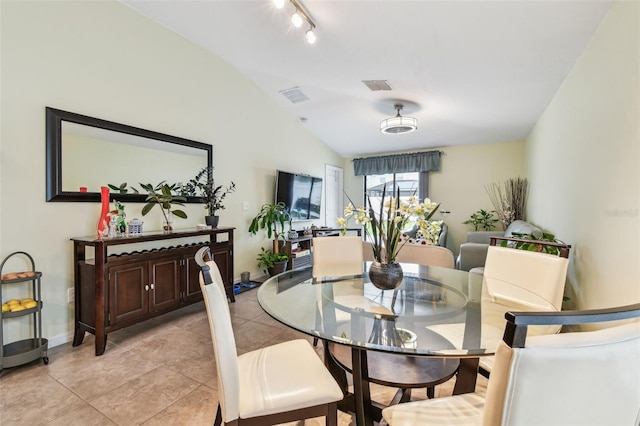 14206 Covert Green Pl, Riverview, FL 33579 - dining space featuring vaulted ceiling, baseboards, light tile patterned flooring, and rail lighting
