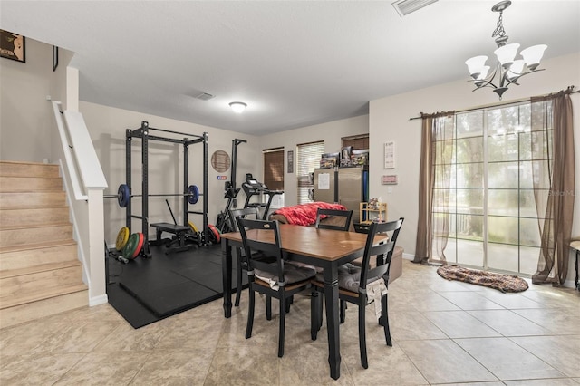 7001 Interbay Blvd Unit 242, Tampa, FL 33616 - dining area featuring a chandelier, stairway, light tile patterned floors, and baseboards