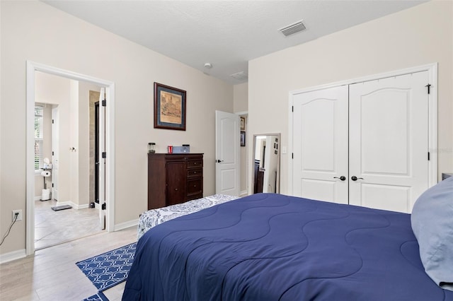 7001 Interbay Blvd Unit 242, Tampa, FL 33616 - bedroom featuring light wood finished floors, a closet, and baseboards