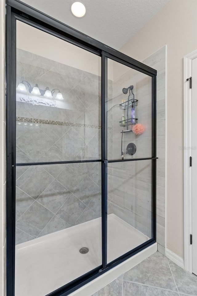 7001 Interbay Blvd Unit 242, Tampa, FL 33616 - full bathroom with a stall shower and tile patterned flooring
