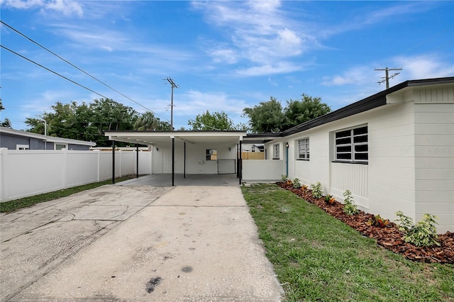 7524 Tidewater Trl, Tampa, FL 33619 - view of yard with concrete driveway and an attached carport