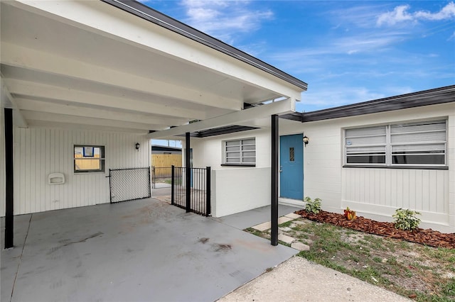 7524 Tidewater Trl, Tampa, FL 33619 - entrance to property featuring a carport and a gate