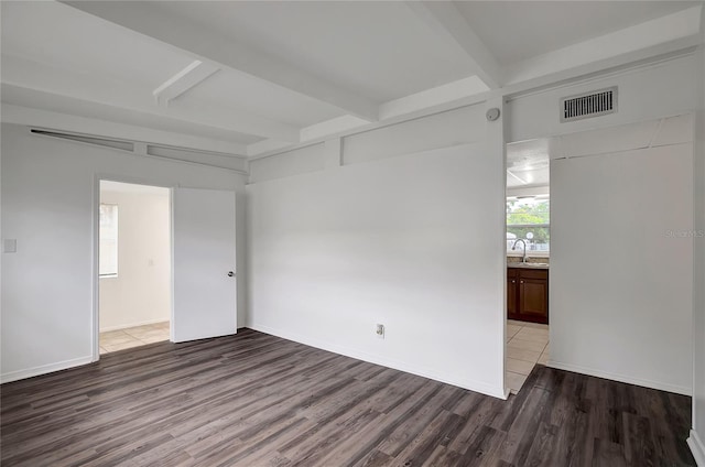 7524 Tidewater Trl, Tampa, FL 33619 - spare room with wood finished floors, a sink, beam ceiling, and baseboards