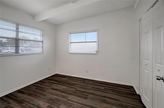 7524 Tidewater Trl, Tampa, FL 33619 - unfurnished bedroom featuring a closet, beamed ceiling, dark wood-style flooring, and baseboards