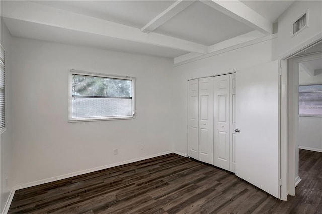 7524 Tidewater Trl, Tampa, FL 33619 - unfurnished bedroom with dark wood-style flooring, beamed ceiling, a closet, and baseboards