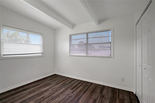 7524 Tidewater Trl, Tampa, FL 33619 - unfurnished bedroom featuring multiple windows, dark wood finished floors, a closet, and beamed ceiling