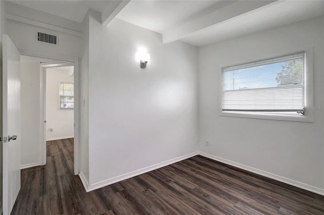 7524 Tidewater Trl, Tampa, FL 33619 - unfurnished room with plenty of natural light, dark wood finished floors, baseboards, and beamed ceiling