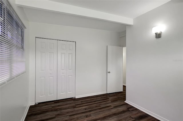 7524 Tidewater Trl, Tampa, FL 33619 - unfurnished bedroom featuring dark wood-style flooring, a closet, and baseboards