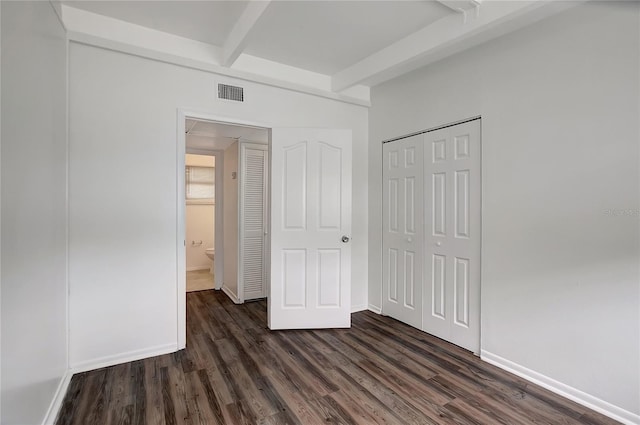 7524 Tidewater Trl, Tampa, FL 33619 - unfurnished bedroom featuring beamed ceiling, dark wood-style flooring, a closet, and baseboards