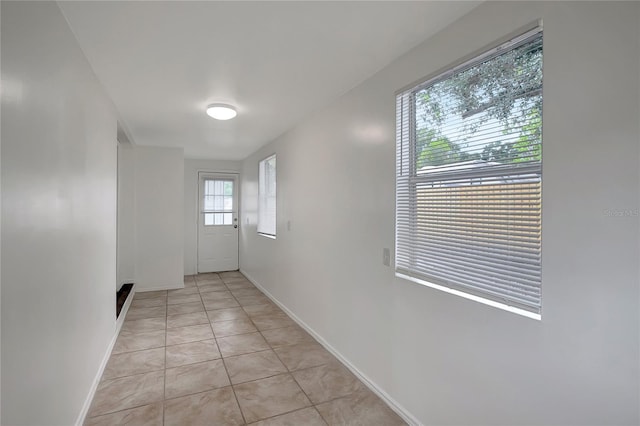 7524 Tidewater Trl, Tampa, FL 33619 - hall featuring baseboards and light tile patterned floors